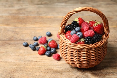 Photo of Mix of ripe berries on wooden table