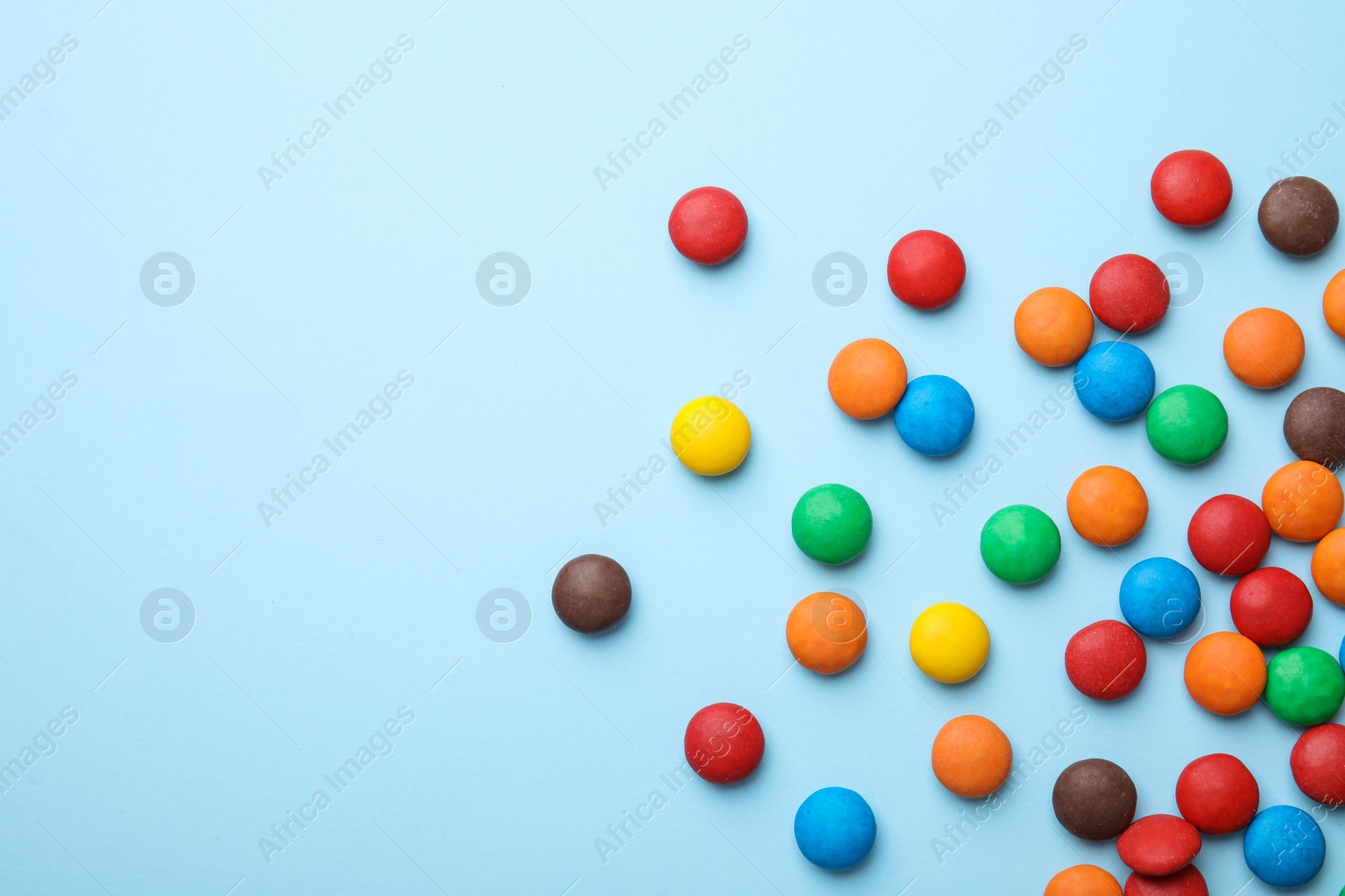Photo of Tasty glazed candies and space for text on color background, top view