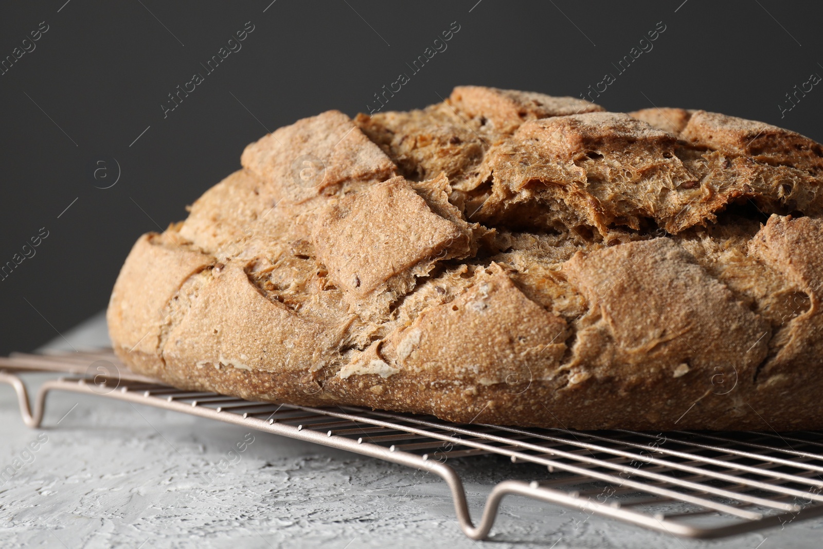 Photo of Freshly baked sourdough bread on grey table, closeup