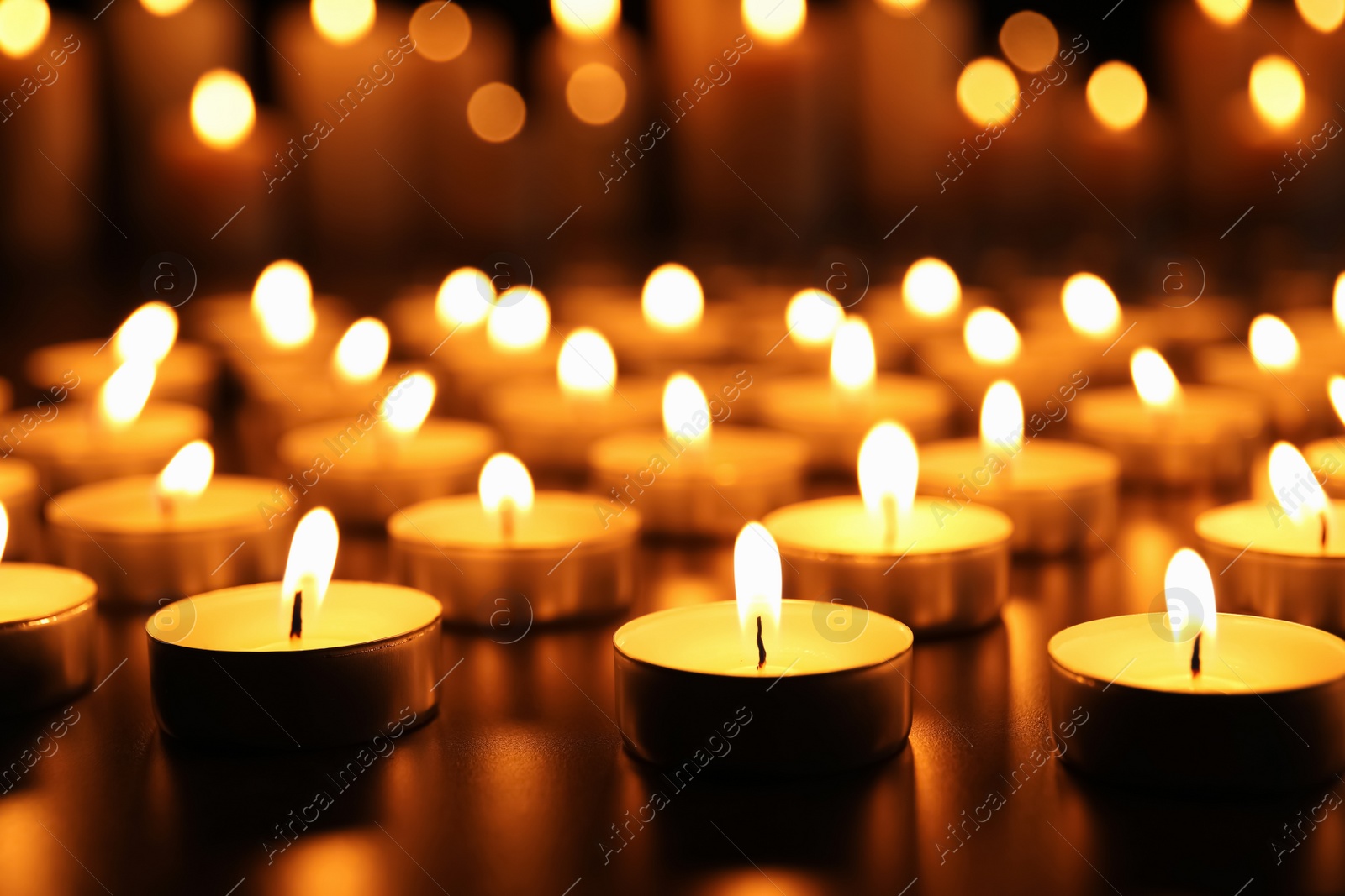 Photo of Many burning candles on table. Memory day