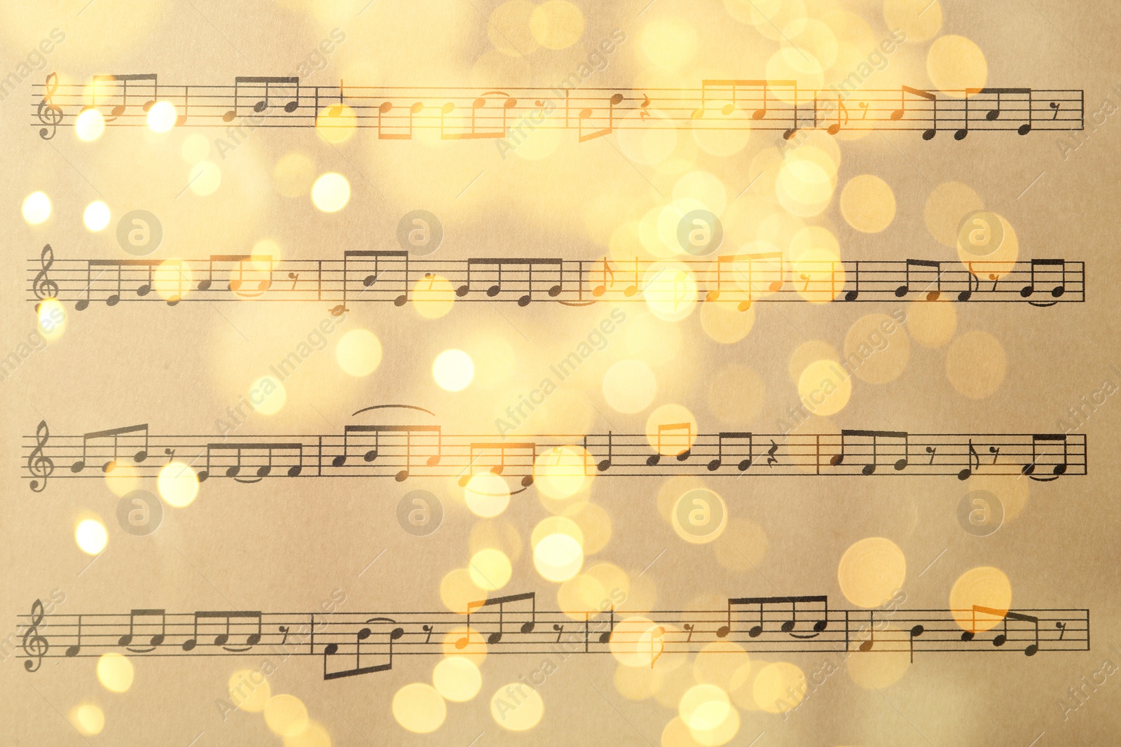 Image of Christmas and New Year music. Music sheet, closeup. Bokeh effect