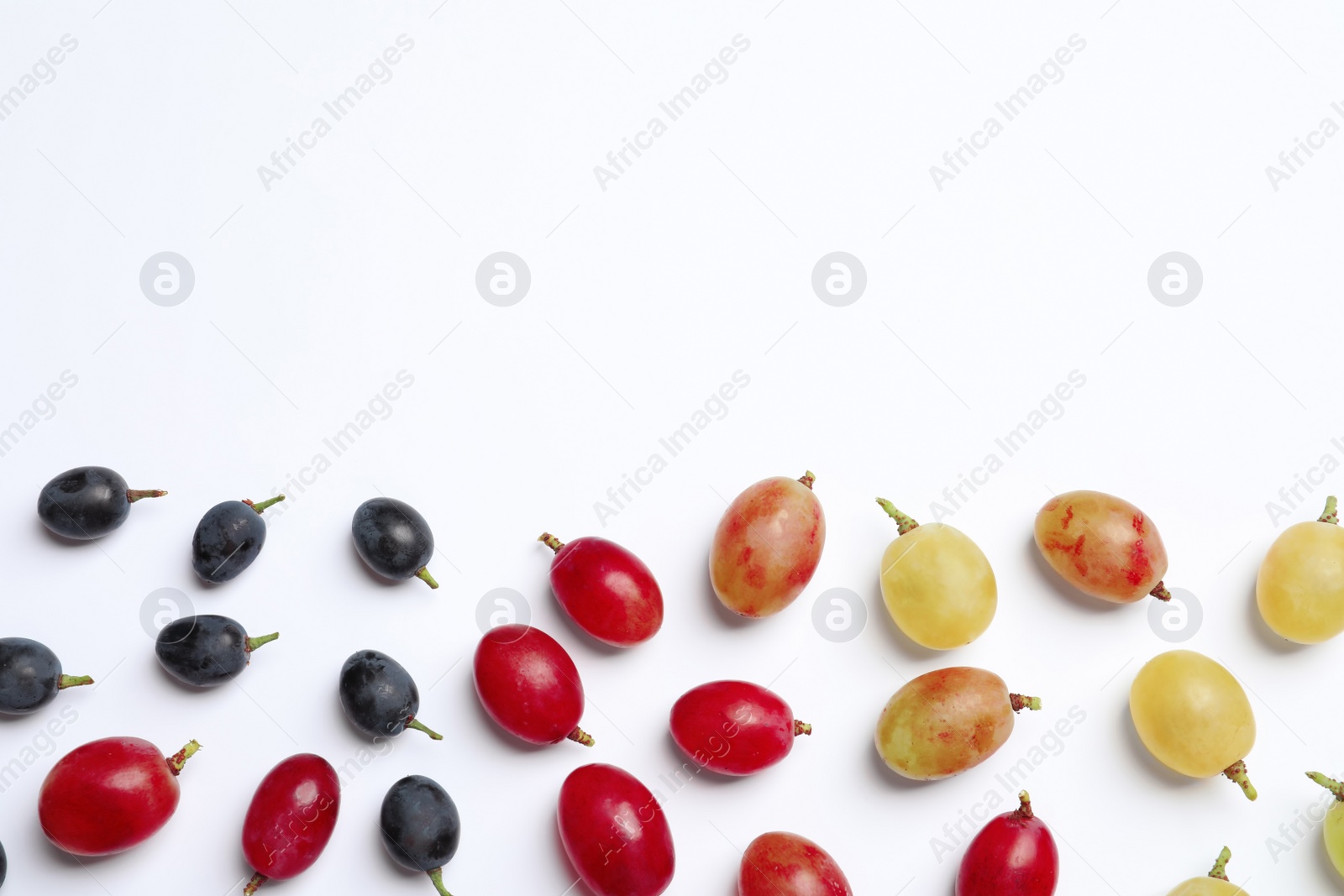 Photo of Fresh ripe juicy grapes on white background, top view. Space for text