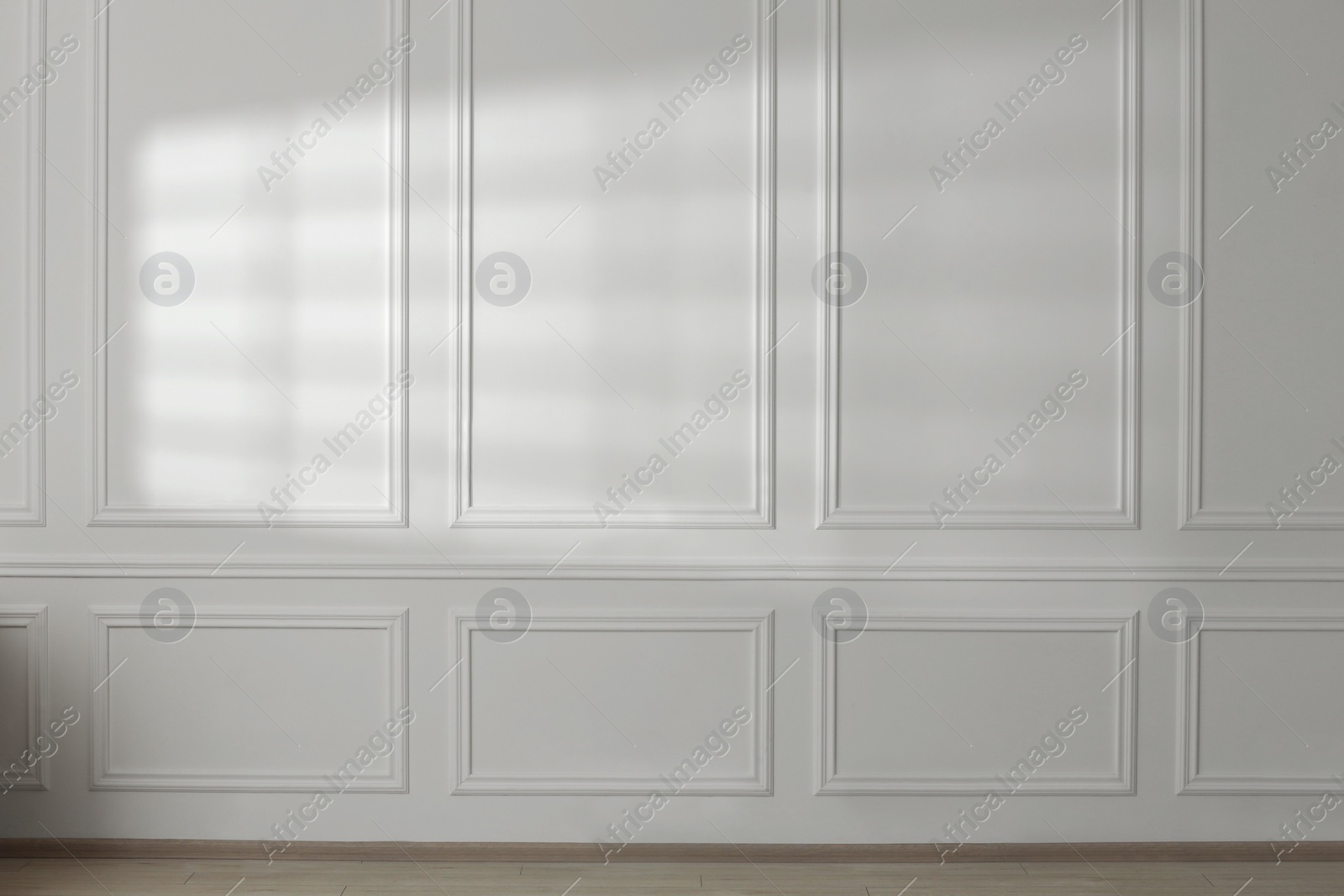 Photo of Light and shadow from window on white wall indoors