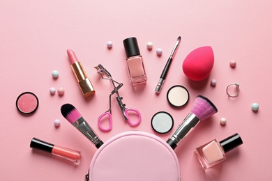 Photo of Flat lay composition with products for decorative makeup on pastel pink background