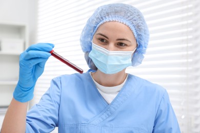 Laboratory testing. Doctor with blood sample in tube at hospital