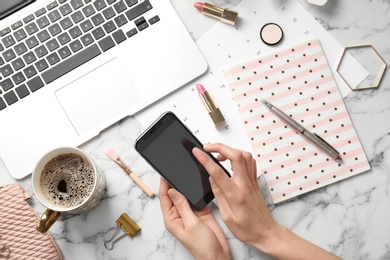 Photo of Woman with mobile phone, laptop and accessories on light background, flat lay. Beauty blogger