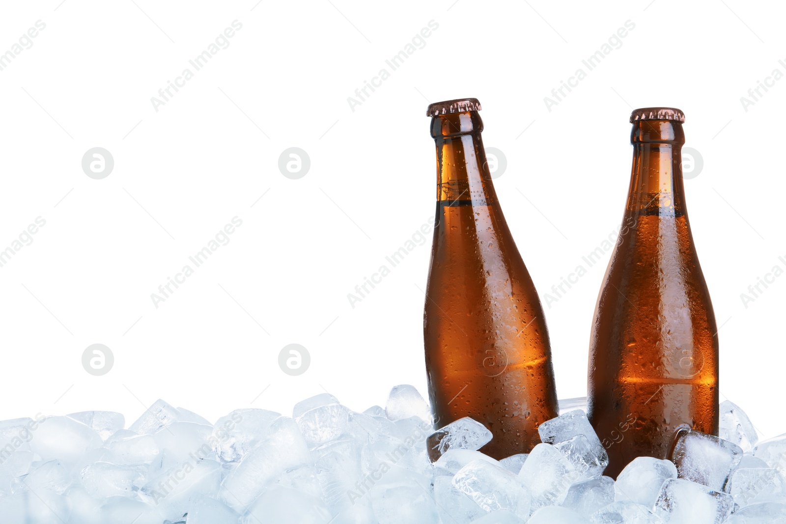 Photo of Ice cubes and bottles of beer on white background