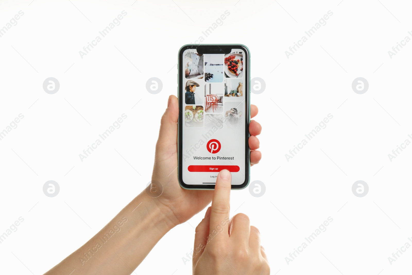 Photo of MYKOLAIV, UKRAINE - JULY 9, 2020: Woman holding  iPhone X with Pinterest app on white background, closeup