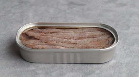 Photo of Canned anchovy fillets on light gray table