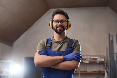 Portrait of professional male carpenter in workshop