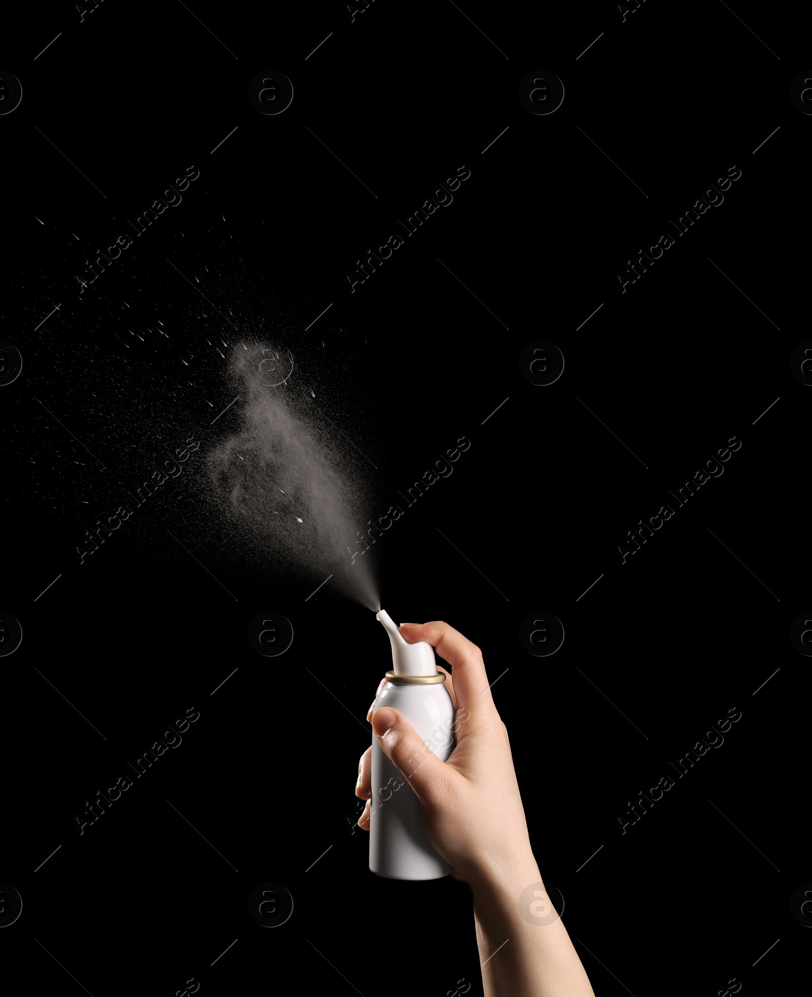 Photo of Nasal congestion. Woman spraying remedy from bottle on black background, closeup with space for text