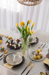 Photo of Beautiful Easter table setting with festive decor indoors