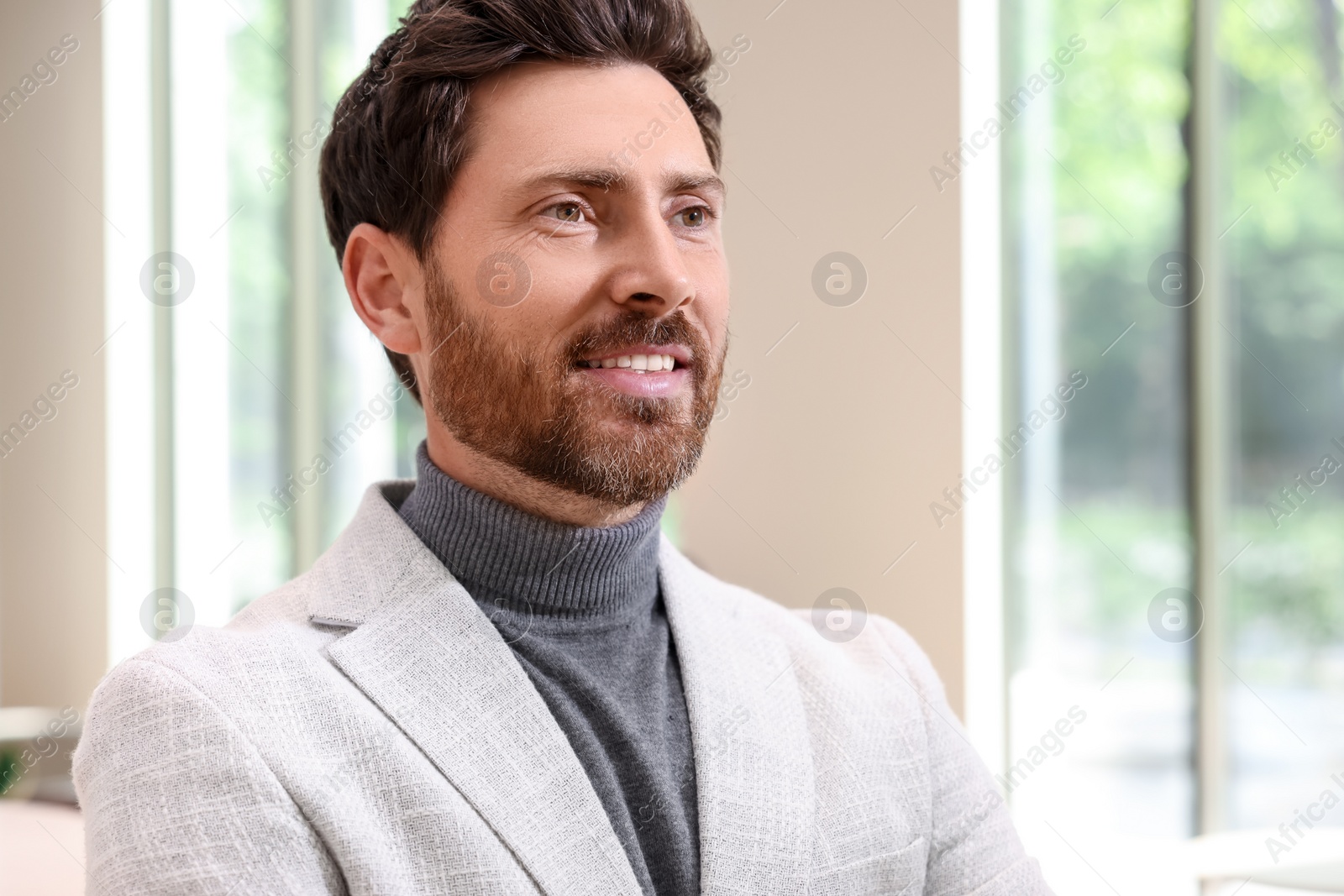 Photo of Portrait of handsome stylish man in office