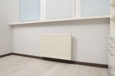 Photo of Modern radiator in room. Central heating system