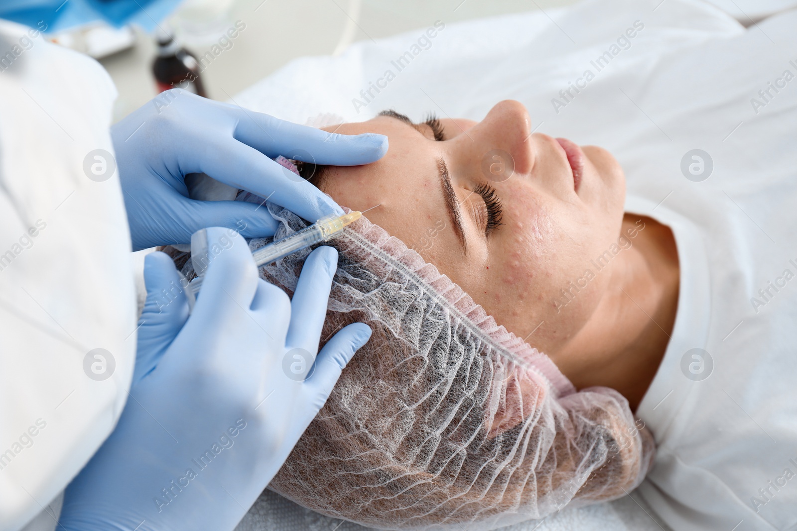 Photo of Woman undergoing face biorevitalization procedure in salon, closeup. Cosmetic treatment