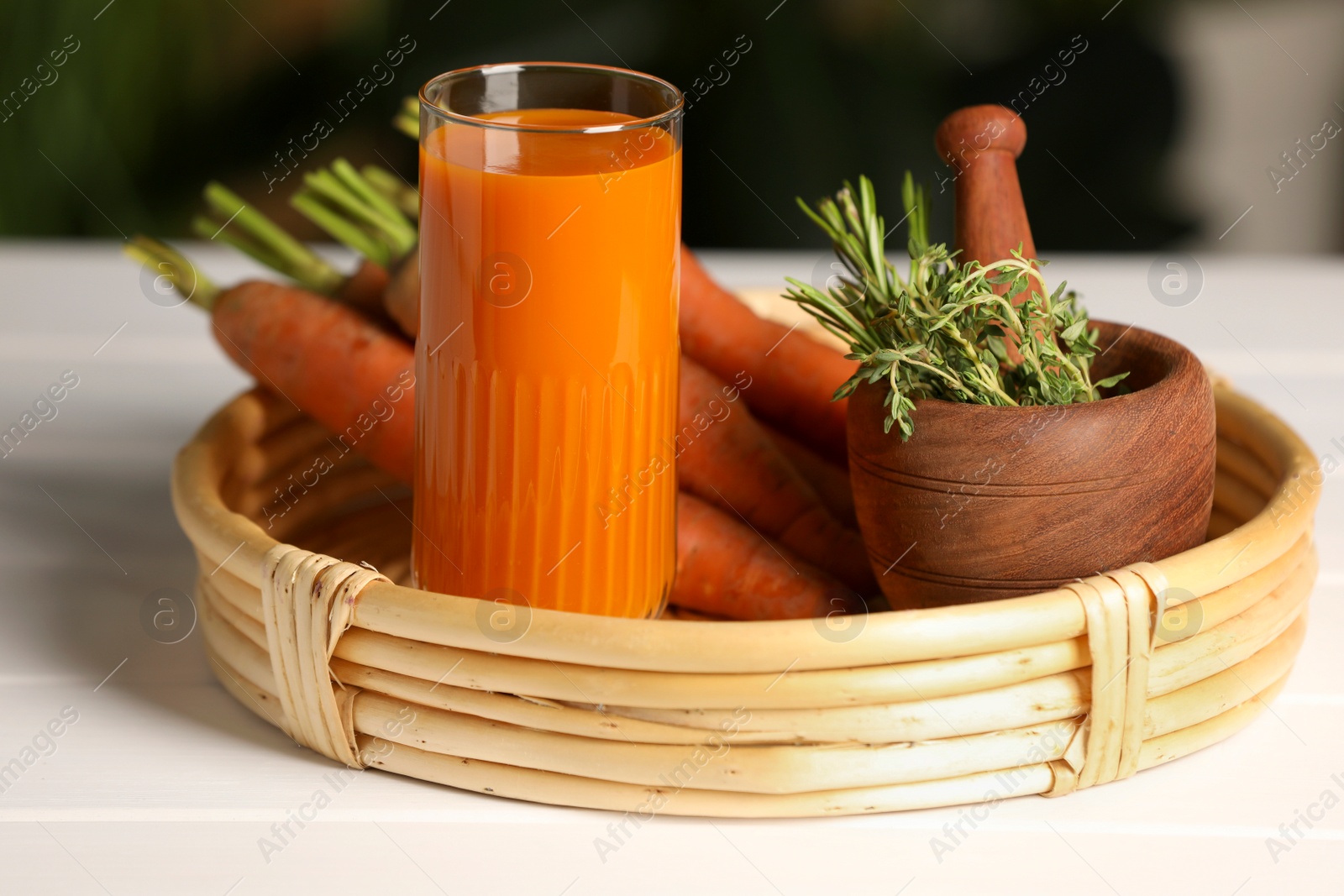 Photo of Tasty juice and ingredients on white wooden table outdoors