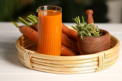 Photo of Tasty juice and ingredients on white wooden table outdoors