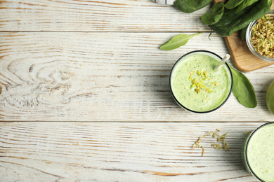 Photo of Flat lay composition with green buckwheat smoothie on white wooden table, space for text