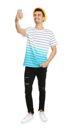 Young handsome man taking selfie against white background