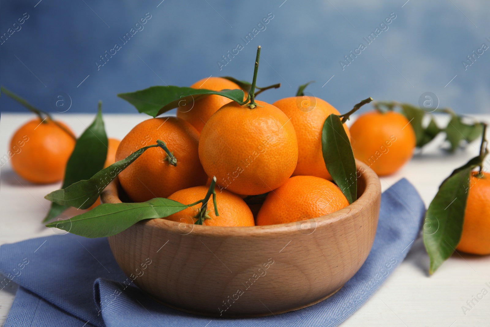 Photo of Fresh ripe tangerines in bowl on table