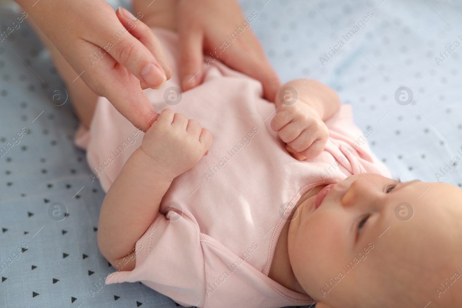 Photo of Mother with her cute little baby in crib