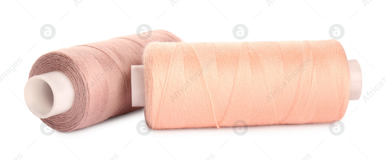 Photo of Different colorful sewing threads on white background, closeup