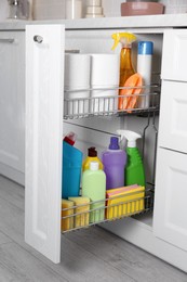 Open drawer with different cleaning supplies in kitchen