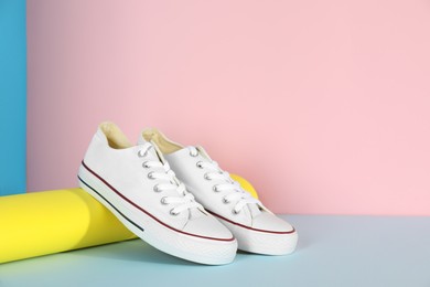 Photo of Pair of stylish sneakers on color background
