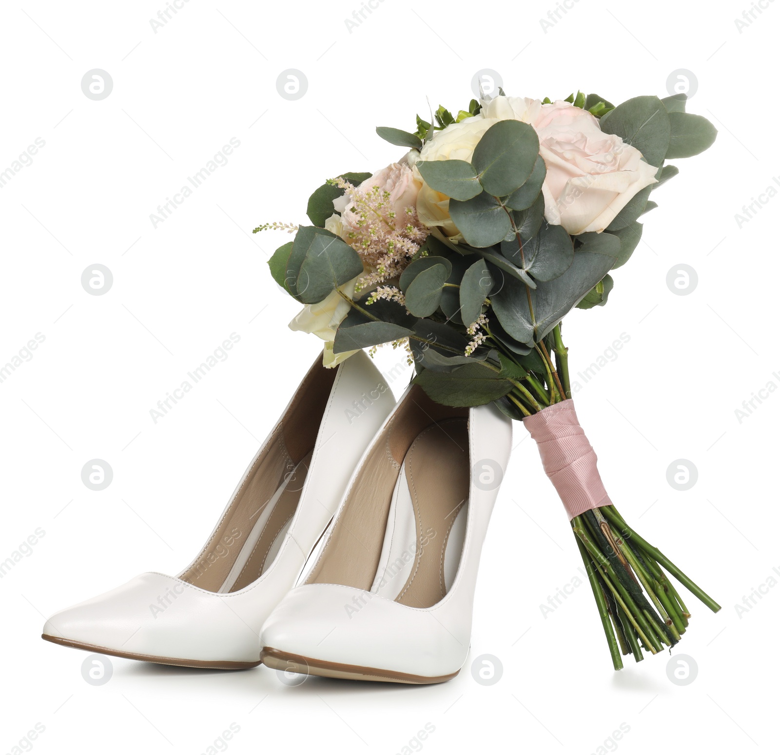 Photo of Pair of wedding high heel shoes and beautiful bouquet on white background