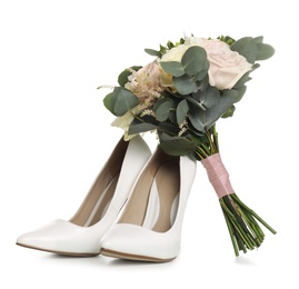 Photo of Pair of wedding high heel shoes and beautiful bouquet on white background