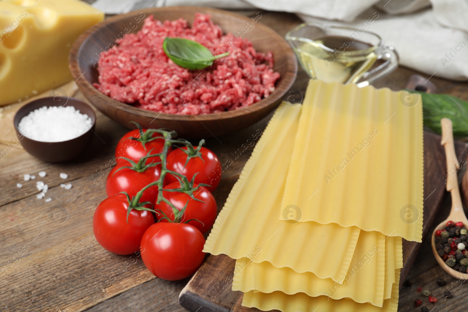 Photo of Fresh ingredients for lasagna on wooden table
