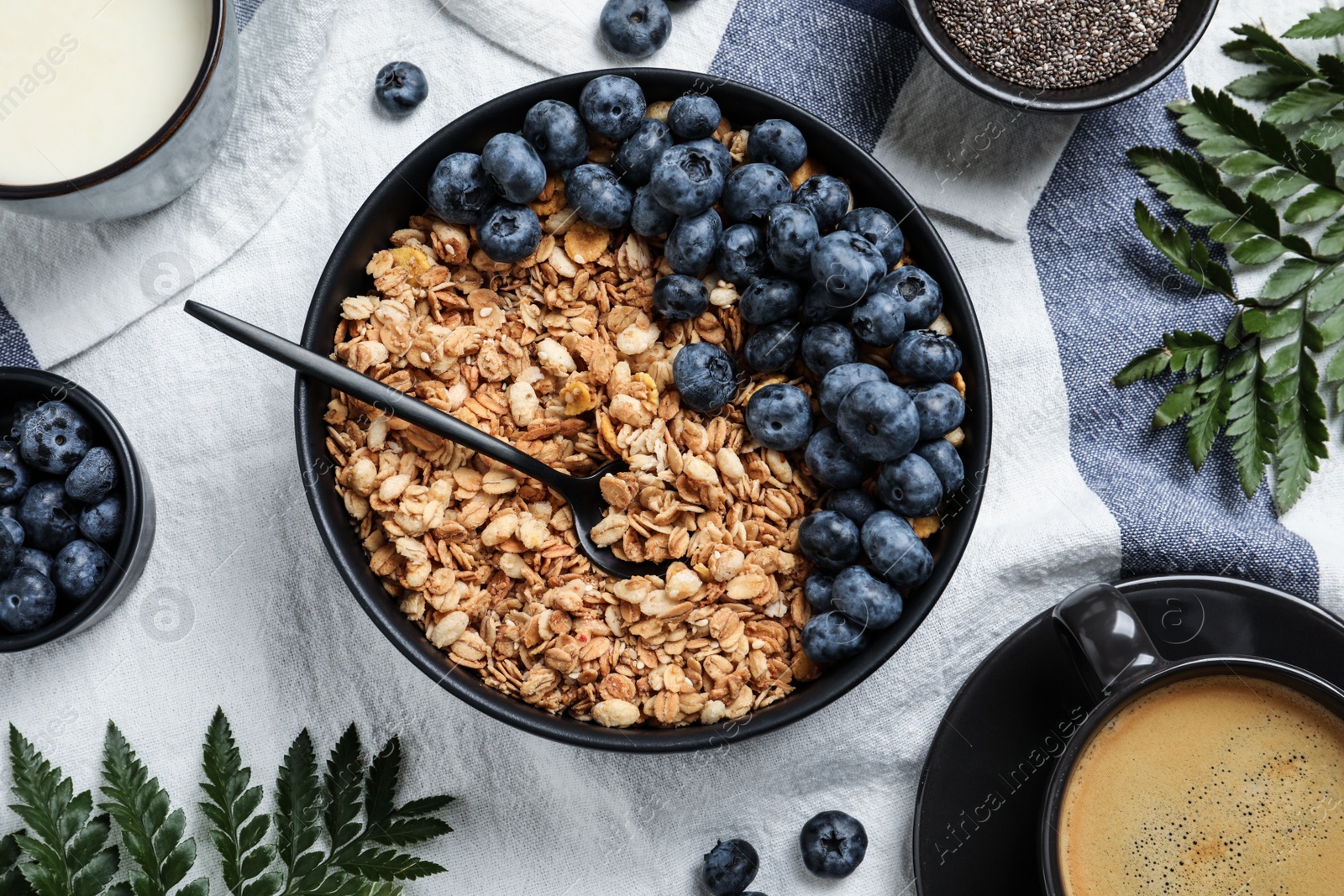 Photo of Bowl of oat with blueberry served on table, flat lay