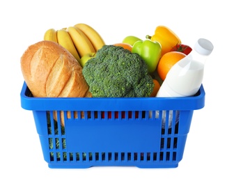 Photo of Shopping basket with grocery products on white background