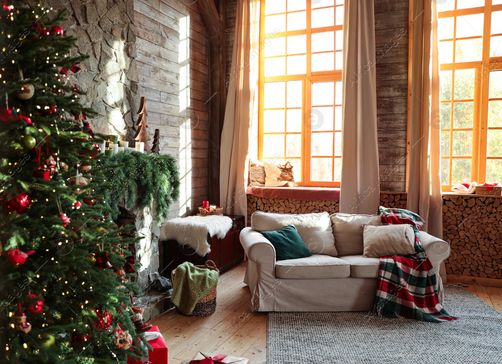 Photo of Festive interior with comfortable sofa and decorated Christmas tree