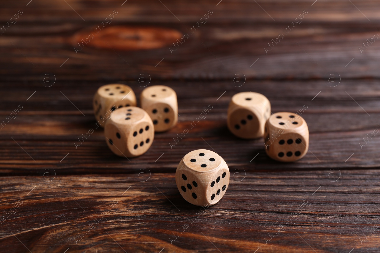 Photo of Many dices on wooden table. Game cubes