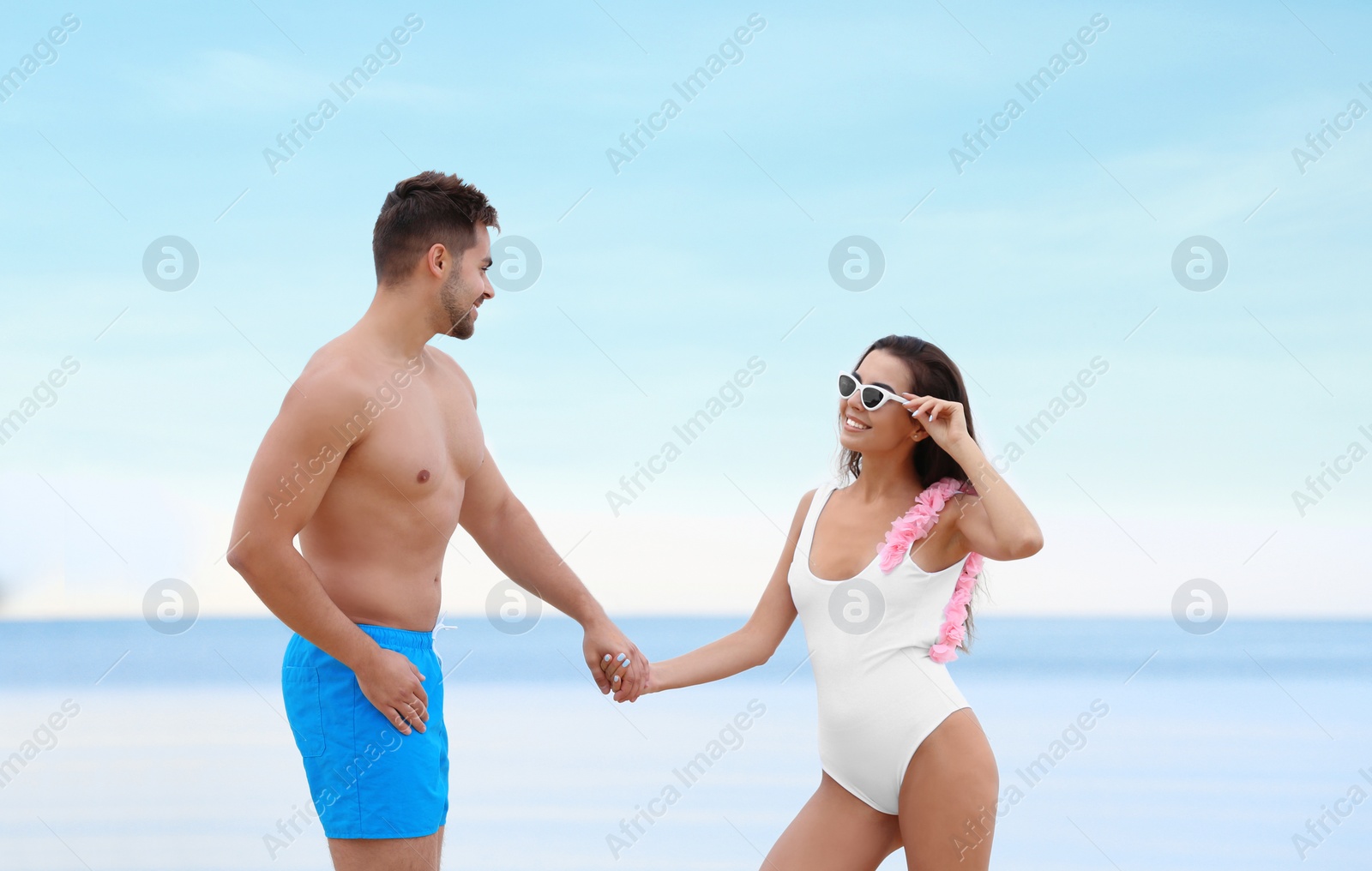 Photo of Happy young couple spending time together on beach