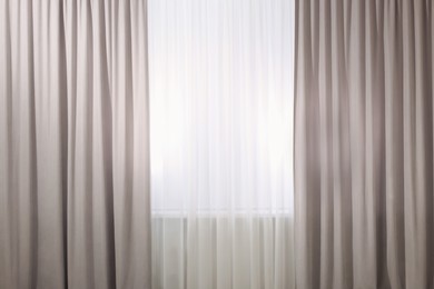 Light grey window curtains and white tulle indoors