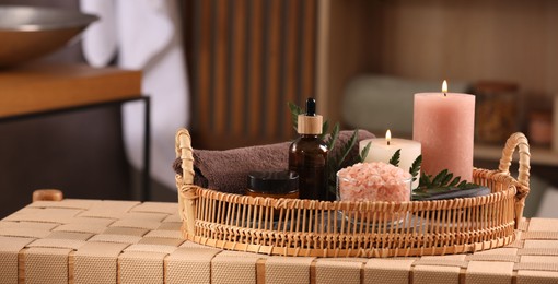 Beautiful composition with different spa products on wicker bench indoors, space for text