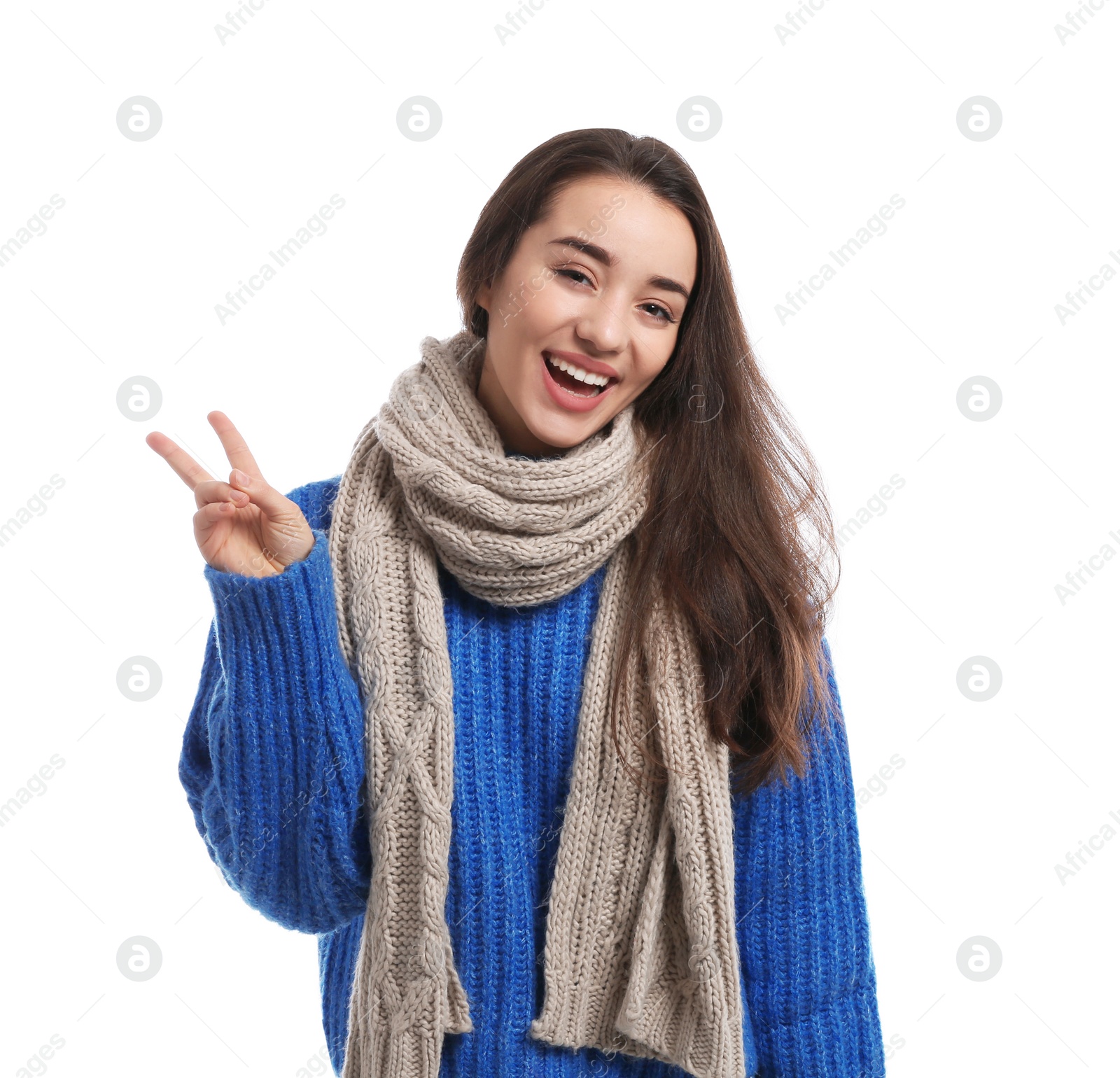 Photo of Young woman wearing warm clothes on white background. Winter season