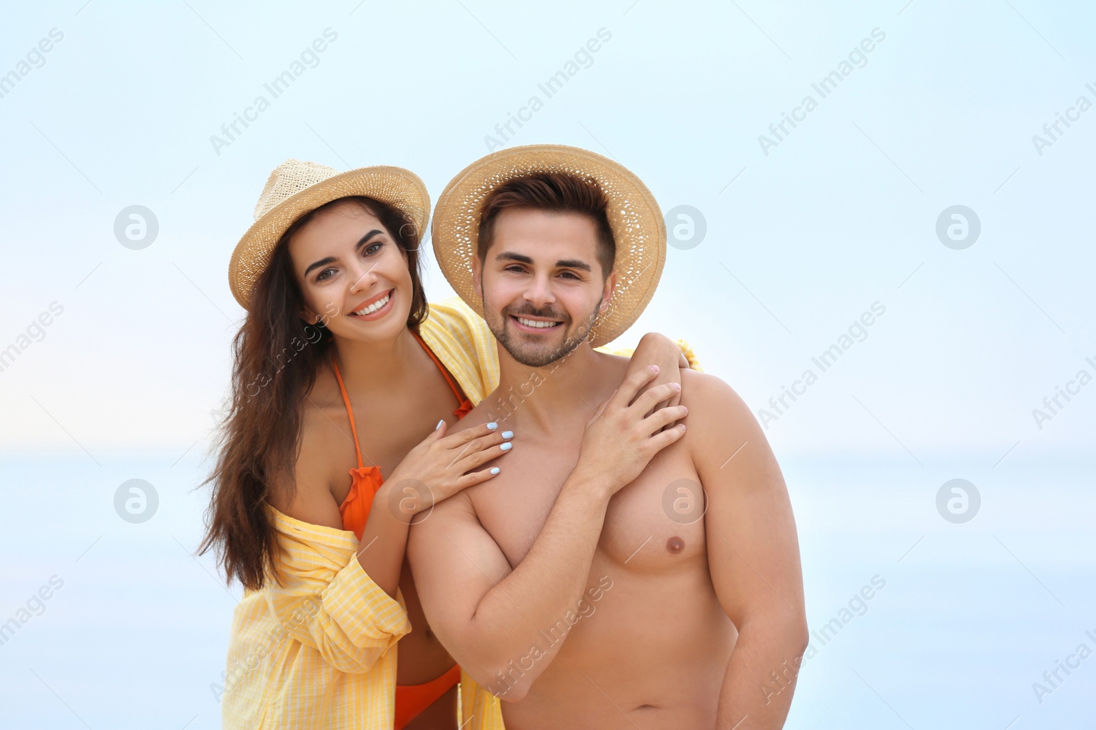 Photo of Happy young couple spending time together on beach