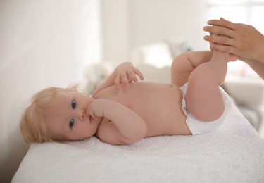 Photo of Mother with her cute little baby indoors