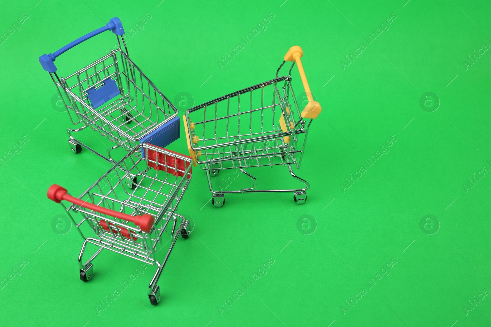 Photo of Empty shopping trolleys on color background, above view. Space for text