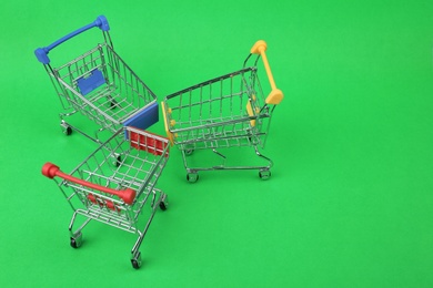 Photo of Empty shopping trolleys on color background, above view. Space for text