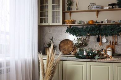 Photo of Stylish kitchen with Christmas decor. Interior design