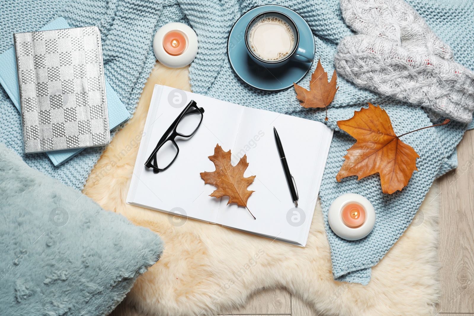 Photo of Flat lay composition with book, cup of coffee and warm blanket on fuzzy rug