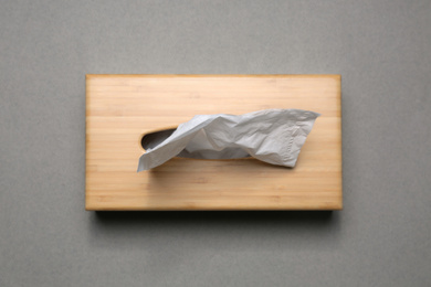 Photo of Holder with paper tissues on grey background, top view