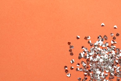 Pile of shiny glitter on pale pink background, flat lay. Space for text
