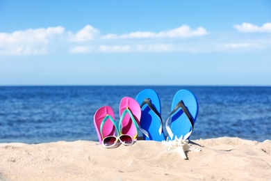 Photo of Composition with beach accessories on sand near sea in summer