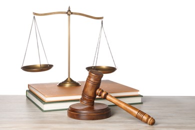 Photo of Law concept. Gavel, scales of justice and books on wooden table against white background