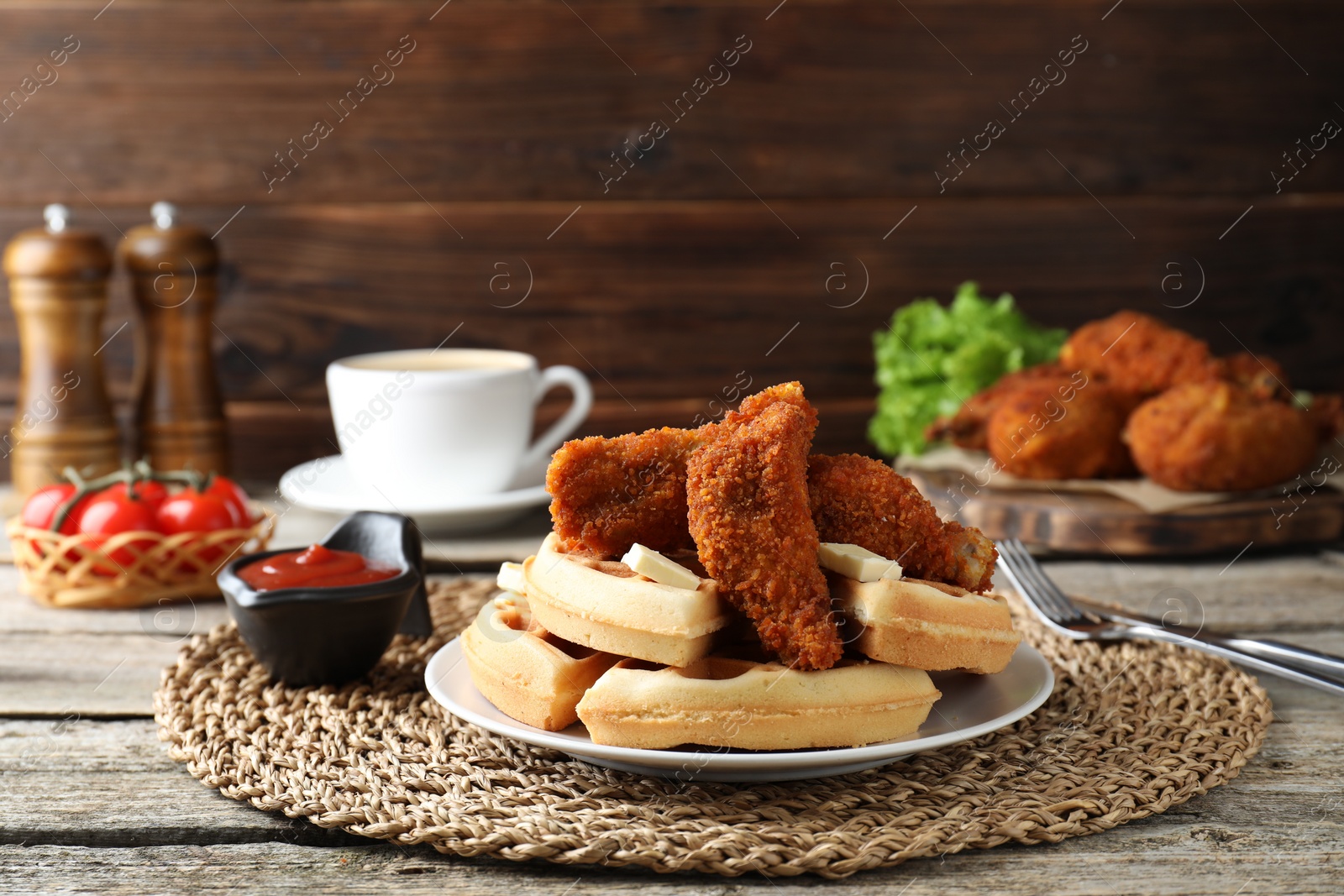 Photo of Delicious Belgium waffles served with fried chicken and butter on wooden table, space for text